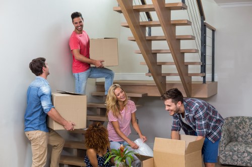 Professional movers assisting with a household move in Crawley