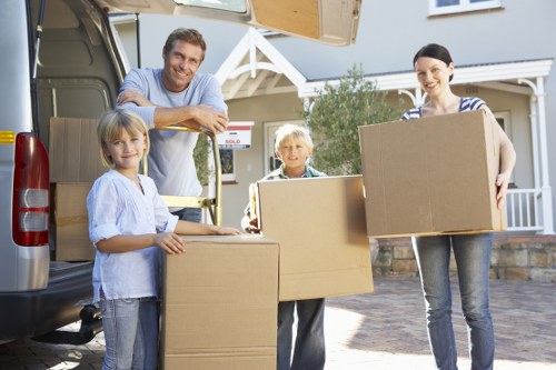 Movers carefully packing items for a move in South West London